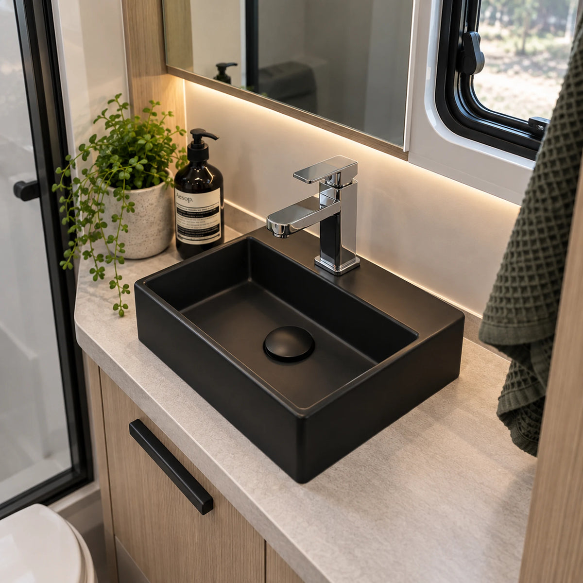 Black caravan RV bathroom basin installed on modern vanity